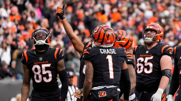Cincinnati Bengals running back Joe Mixon (28) pulls a coin from his first band and flips it in the end zone after running in a touchdown in the first quarter of the NFL Week 18 game between the Cincinnati Bengals and the Baltimore Ravens at Paycor Stadium in downtown Cincinnati on Sunday, Jan. 8, 2023. The Bengals led 24-7 at halftime. Baltimore Ravens At Cincinnati Bengals Nfl Week 18